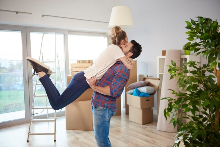 Smooth Move Moving Services in South Carolina | young couple at home surrounded by cardboard boxes